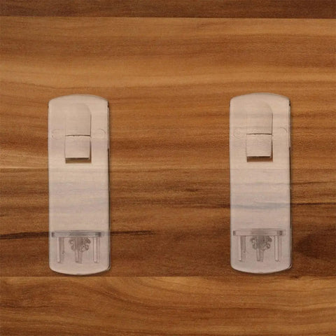 Clear Plastic Shelf Support Pegs 50 Pack For Cabinets, Bookshelves, And Bathrooms against wooden surface