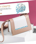 Crossbody bag with beige faux leather and white front panel, blue metal stud trim along bottom.