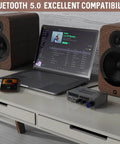 Dope Little Power Amplifier For Home Audio With 2 Channel Bluetooth 300W Max Output next to laptop and speakers on a desk