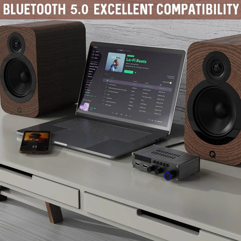 Dope Little Power Amplifier For Home Audio With 2 Channel Bluetooth 300W Max Output next to laptop and speakers on a desk