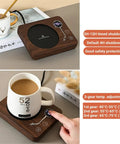 Smart Cup Heater And Mug Warmer With Three Adjustable Levels And Auto Timing Off on a wooden electric heating coaster.