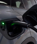Dead Simple 16 Amp Level One Portable Ev Charger connected to vehicle charging port with green indicator light.