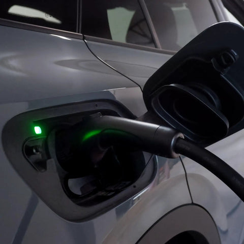 Dead Simple 16 Amp Level One Portable Ev Charger connected to vehicle charging port with green indicator light.