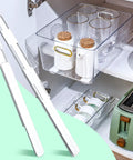 No Sweat Self Adhesive Drawer Slides Four Pack near cups and glasses in cabinet for easy sliding installation.