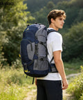 Person hiking with 60L Waterproof Hiking Backpack With Rain Cover Heavy Duty Nylon Daypack Rucksack For Camping And Travel, outdoors