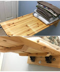 Heavy Duty Stainless Steel Folding Table Leg Brackets With Self Locking Hinges Built Different For Heavy Lifters Zero Drama Assembly Nifty Foldable Support Kit Kick Butt Strength For Workbenches holding neatly stacked towels.