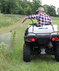 Person using a 15 Gallon UTV And ATV Spot Sprayer With 1.0 GPM Pump, 40 PSI Max, Adjustable Spray Gun for weeds in a field