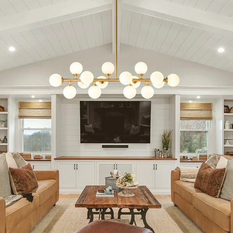 Mid Century Modern Sputnik Chandelier With 16 Lights Brushed Brass Arms And Frosted Milk Glass Shades hanging over a cozy seating area.