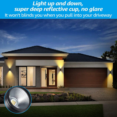 House with Integrated LED Cylinder Up Down Outdoor Wall Light, slick aluminum waterproof sconce illuminating front porch at night.