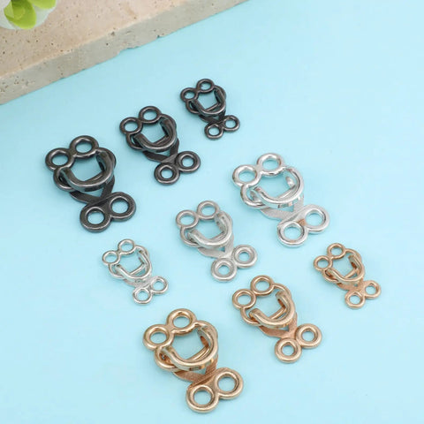 Assorted zinc alloy hook and eye closures in silver, gold, and black for Heavy Duty Hook And Eye Sewing Kit.
