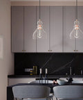 Modern Industrial Farmhouse 6.5 Inch Hand Blown Seeded Glass Pendant Lights In Washed Copper Finish Dope 3 Pack illuminated over dining table