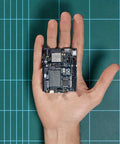 Uno R4 WiFi Dual Core Microcontroller Board With Renesas RA4M1 And ESP32 S3 in a hand, showing compact size and design for IoT projects.