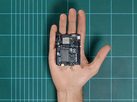 Uno R4 WiFi Dual Core Microcontroller Board With Renesas RA4M1 And ESP32 S3 in a hand, showing compact size and design for IoT projects.