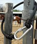 Straight Up Heavy Duty Horse Gate Latch With Rust Resistant Nylon Steel Tie Rope attached to a fence post with a carabiner.