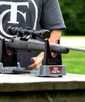 Person setting up gun on Compact Range Vise With Folding Forks And NonMarring Cradle for Safe Firearm Cleaning and NonSlip Feet