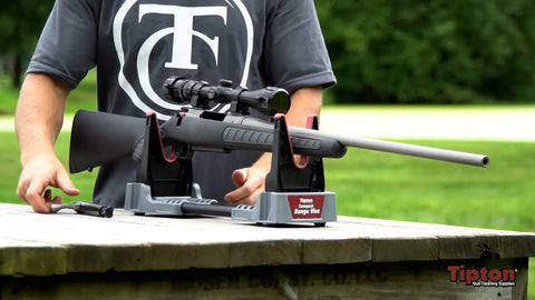 Person setting up gun on Compact Range Vise With Folding Forks And NonMarring Cradle for Safe Firearm Cleaning and NonSlip Feet