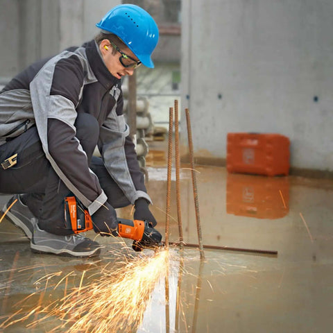 Worker using Professional Cordless Angle Grinder Runs Smooth And Hits Hard With Multi Volt Battery Interface on steel rebar.