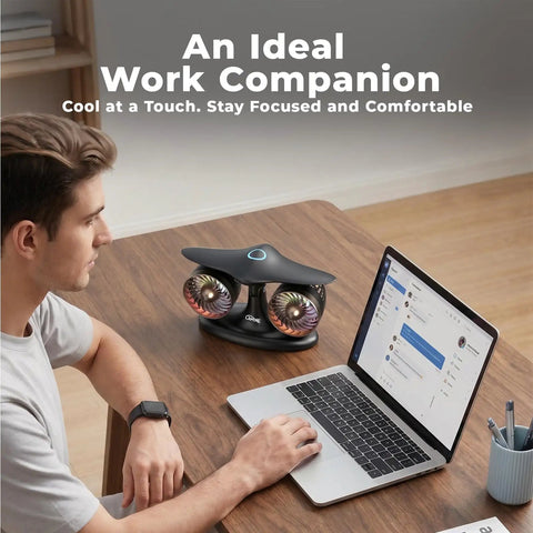 Jet Engine Desk Fan With Eighteen Hour Runtime USB C Rechargeable Turbo Table Fan on a wooden desk beside a laptop and man.