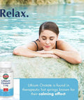 Lithium Orotate Mood Support Supplement bottle in front of woman relaxing in hot spring, promoting calm vibes and mood stability.