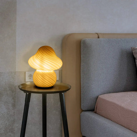Desert Swirl Mushroom Lamp With Stepless Dimmable Glass Shade on bedside table by bed, warm white LED bulb glowing