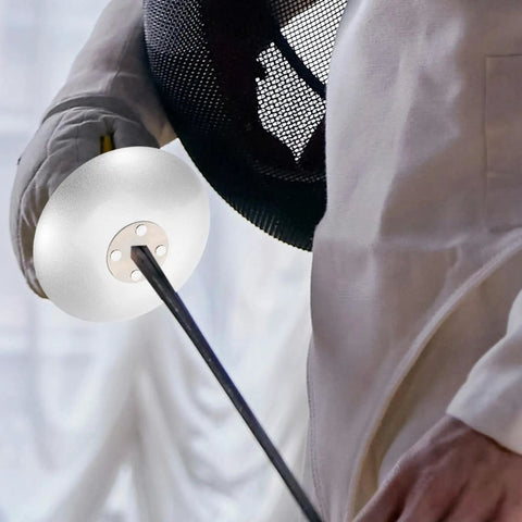 Close-up of a fencer holding a foil with guard, wearing competition gear. Fencing Accessories Set With Foil Guard And Hand Pads.