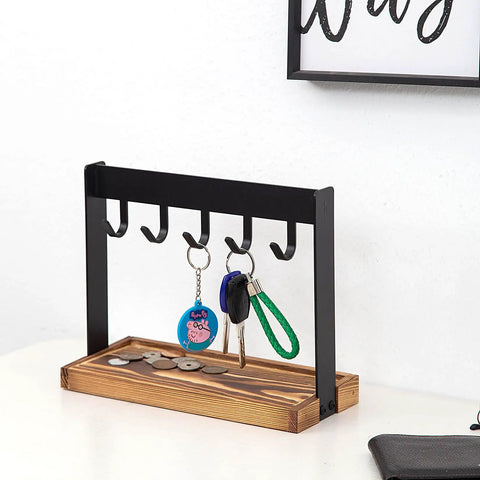 Solid Five Hook Table Key Holder With Torched Wood Base And Rustic Industrial Countertop Rack in black and wood, holding keys and coins.