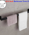 24 Inch Contemporary Stainless Steel Towel Bar Wall Mount With Slick Matte Black Finish holding towels in a bathroom setting