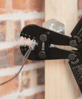 Heavy Duty Wire Rope Crimping Tool Kit With Swager And Cutter in use on cable against brick wall