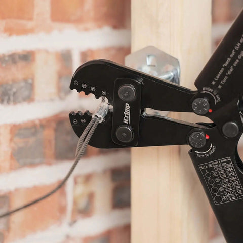 Heavy Duty Wire Rope Crimping Tool Kit With Swager And Cutter in use on cable against brick wall