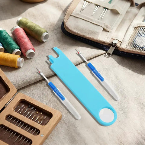 3 In 1 Needle Threader With Magnifier For Sewing, Quick Threading Tool With Magnetic Mount And Integrated Ruler, Anti Prick Stitch Insertion Kit, Includes 2 Seam Rippers For Quilting And Easy Eye Strain Relief on a crafting table.