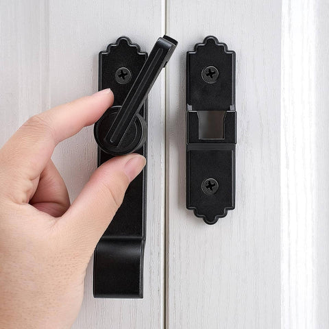Hand operating 180-degree black barn door lock with handle on white door, part of Pack Of 3 180 Degree Black Barn Door Locks And Latches With Handle For Cabinets Bathroom Closet Window Garage Security Lock Set Heavy Duty Sliding Door Latch.