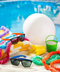 White 11 Inch Inflatable Beach Balls, 12 Pack for Pool Parties and Beach Games beside towels and poolside accessories.