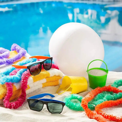 White 11 Inch Inflatable Beach Balls, 12 Pack for Pool Parties and Beach Games beside towels and poolside accessories.