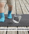 Child's feet on Heavy Duty Non Slip Floor Mat 4X10 Grey Drainage Rubber Deck Mat For Commercial Bars Kitchens And Pools anti-fatigue surface.