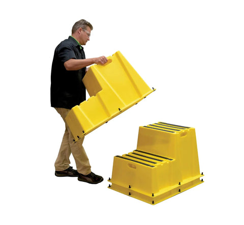 Person stacking yellow Nestable Polyethylene 2 Step Stool with 500 lb capacity, showing anti-slip treads and side handles