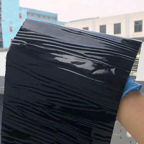 Tough As Nails Self Adhesive Roofing Underlayment Roll, heavy duty polyethylene tape being held outdoors.