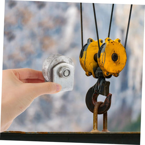 Person holding a 4-inch V-groove gate wheel near industrial pulley system.