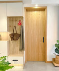 Room view with wooden door featuring adhesive drawer pull handle, part of 4 Pack Peel And Stick Cabinet Handles in black finish.