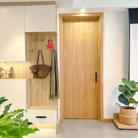 Room view with wooden door featuring adhesive drawer pull handle, part of 4 Pack Peel And Stick Cabinet Handles in black finish.