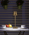 Cordless Table Lamp 2 Pack With 5000mAh Rechargeable Battery Metal USB LED Desk Light on a table with cups and fruit, antiqued gold finish