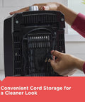 Hand wraps cord underneath a black Two Slice Toaster With Extra Wide Slots For Bagels And Thick Bread, 850W Power, waffle friendly.
