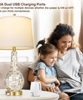 Gold Table Lamps Set Of 2 For Living Room With Shell Tile Inset shown with USB charging next to a mother and child on sofa.