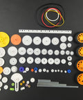 82 Piece Plastic Gear Kit For DIY Toy Cars And Robots Complete Gear Pack With various gears, axles, tires, belts on display.