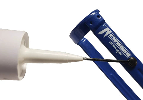 Close-up of Pro Grade Caulking Gun With 18 To 1 Thrust, Revolving Barrel, Smooth Zinc Alloy Handle, One-Tenth Gallon Cartridge.