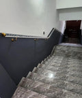 Clear Acrylic Stair Handrail With Heavy Duty Gold Brackets Wall Mount on indoor staircase for safe navigation.