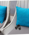 Outdoor sofa with blue cushions and a black clip, showing use of 24 Pack Outdoor Furniture Clips For Patio Wicker And Rattan Sofas.