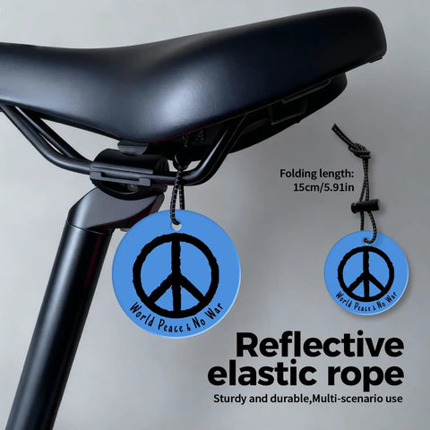 Bicycle seat with World Peace Reflective Gear For Nighttime Safety You Can Toss On Backpacks Bicycles Pet Ropes Clothes And Keychains Blue Double Sided Brightness Waterproof Lightweight 2.56 Inch Disc attached.