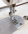 Close-up of sewing machine with Pro Grade Finger Guard Shield for Industrial Single Needle Sewing Machines installed on foot.