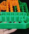 Slick Heavy Duty Spot Welding Jig For 18650 And 21700 Battery Packs - Green insulated holder with slots for cell stability.