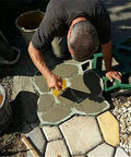 Man using Heavy Duty Concrete Molds Large Size For DIY Paving, Reusable Cement Molds For Patio And Garden Paths to create stepping stones.